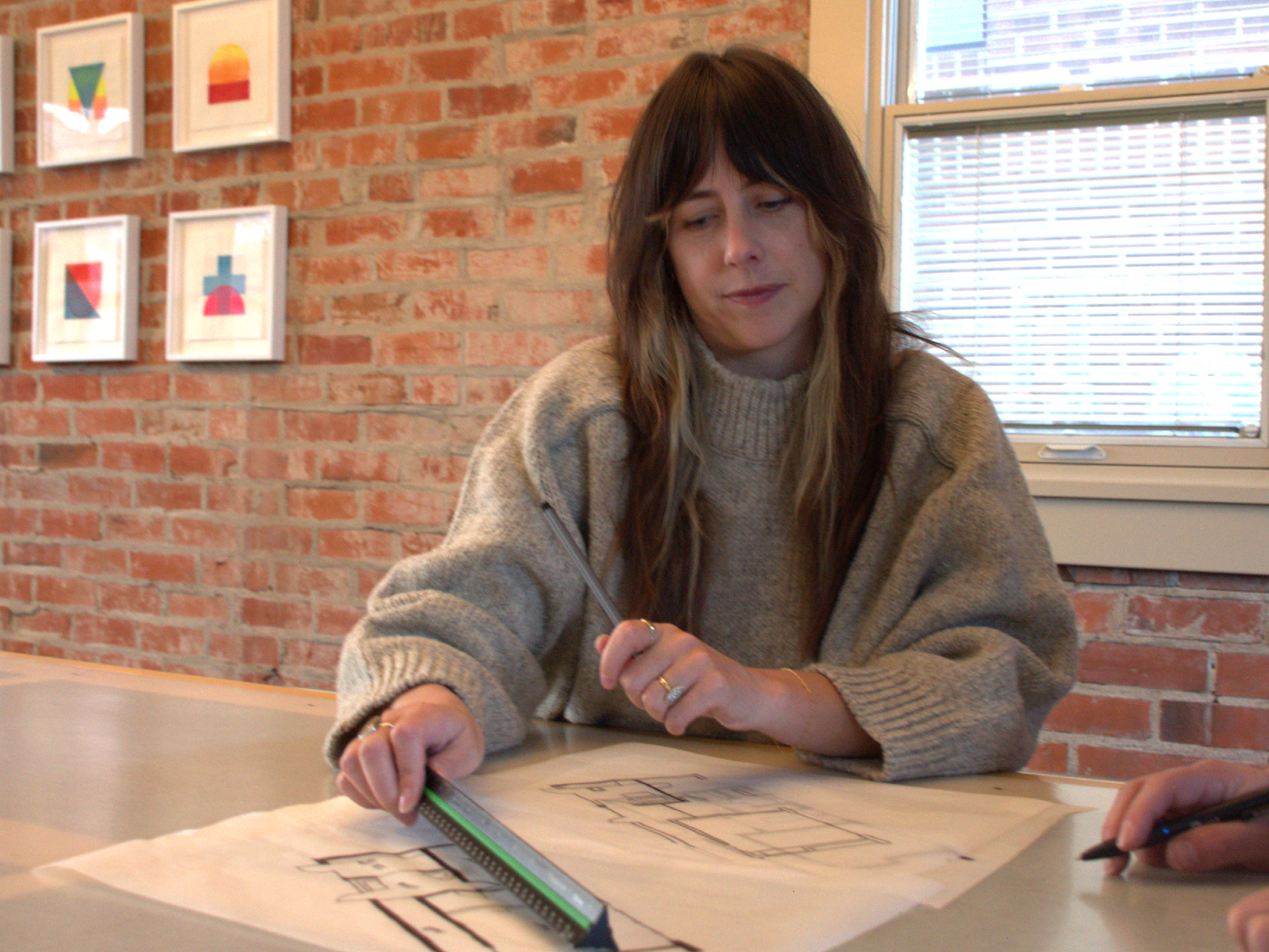 Close-up of architect sketching and reviewing a residential floor plan